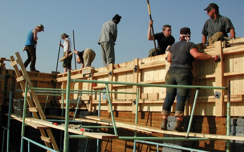 Tegen drie uur ’s middags trok het personeel van DMOA de emmers beton naar boven. "Vervolgens deden we per dag vier laagjes, dus telkens 40 cm. Om het uur een nieuwe. In totaal zijn we zo drie maanden met veel plezier bezig geweest" (foto: DMOA architecten)
